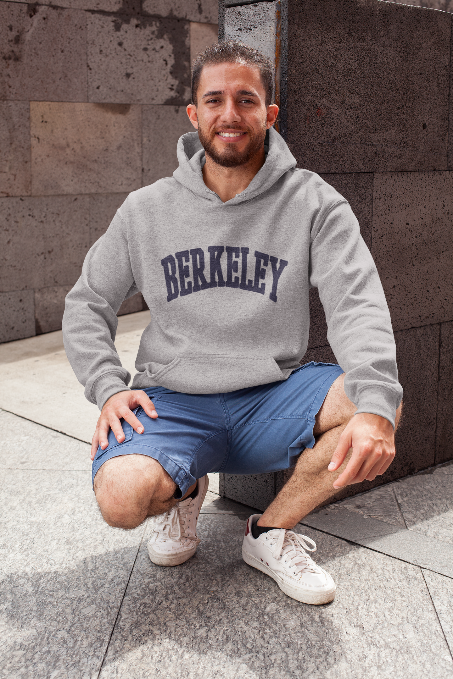 heathered-hoodie-pullover-mockup-featuring-a-smiling-man-in-a-crouching-position-28629.png